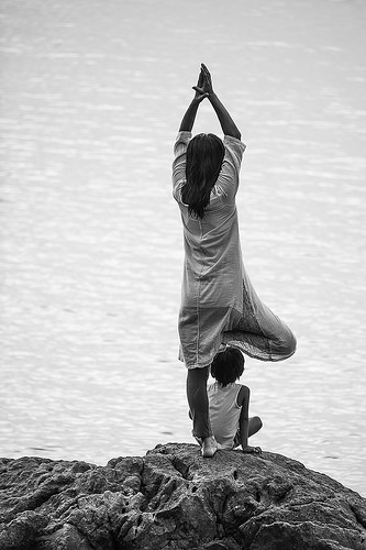 Woman meditating by oceanside